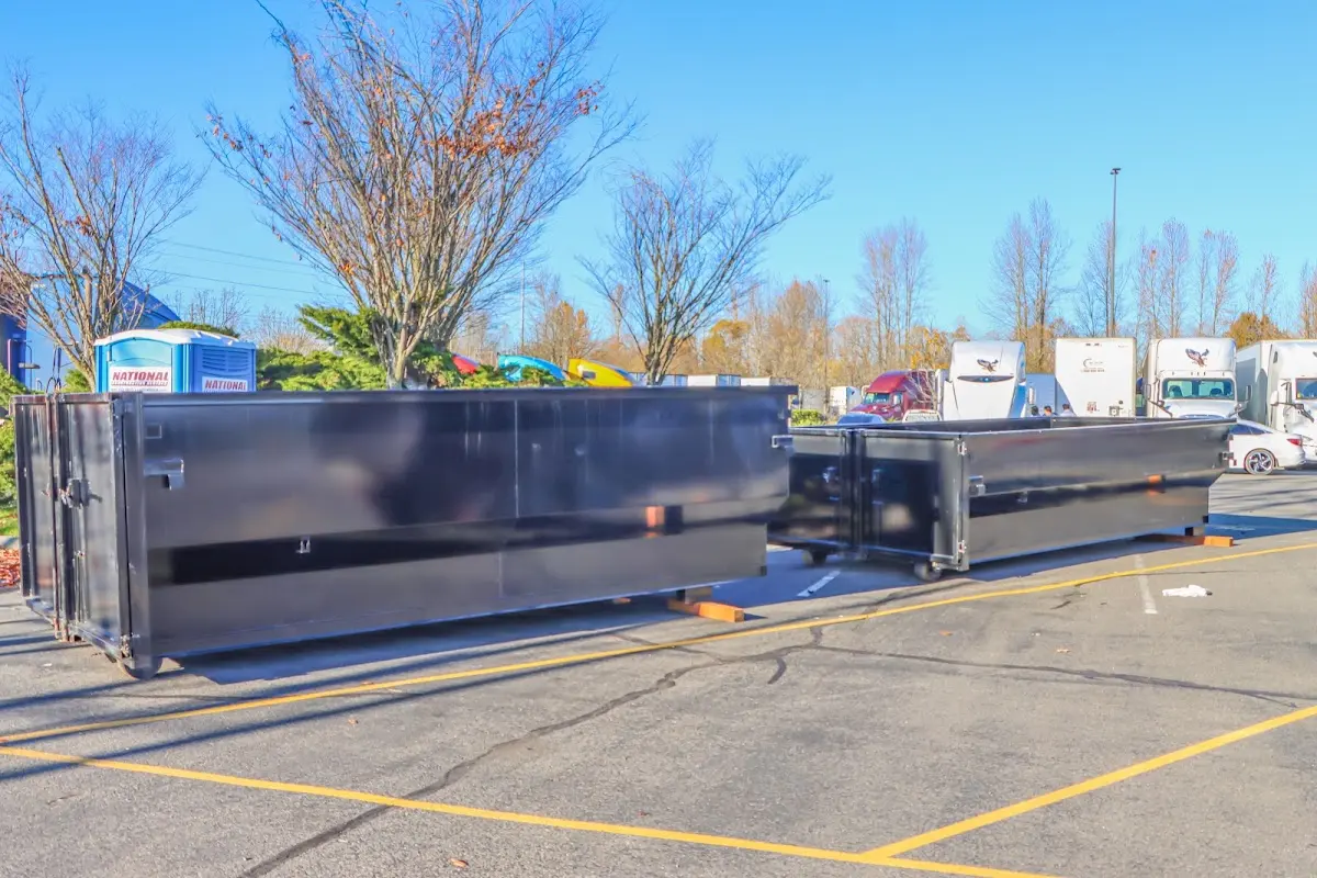 Professional dumpster rental service with roll-off container on residential driveway in Catasauqua